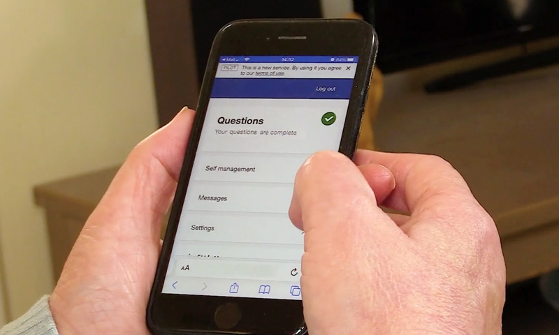Patient using a smart phone app to answer daily health questions